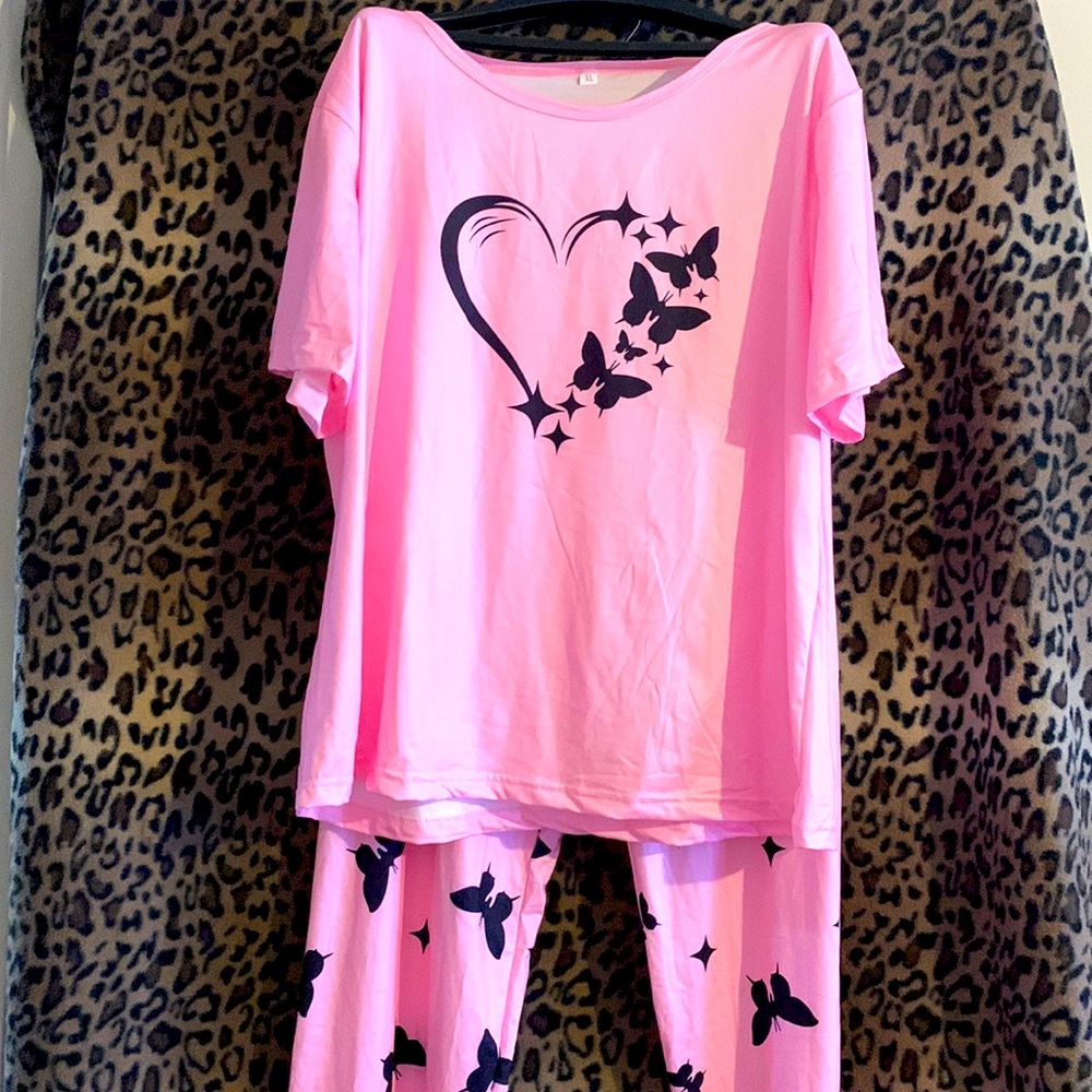 Cute pink and black pajamas made of polyester and elastase. Never been worn